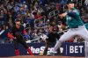 Toronto Blue Jays' George Springer (4) takes a lead off first base as Seattle Mariners starting pitcher Bryan Woo (22) throws to a Blue Jays batter in second inning MLB baseball action in Toronto on Friday, April 18, 2025. THE CANADIAN PRESS/Jon Blacker