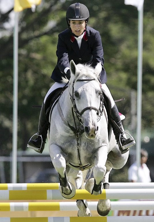 FILE - Philippines’ Mikaela Jaworski with horse Globe Platinum Leap of Faith clears an obstacle at a speed course during the equestrian individual qualifying event at 23rd South East Asian Games in suburban Alabang, south of Manila, Philippines on Thursday, Dec. 1, 2005. (AP Photo/Aaron Favila, File)