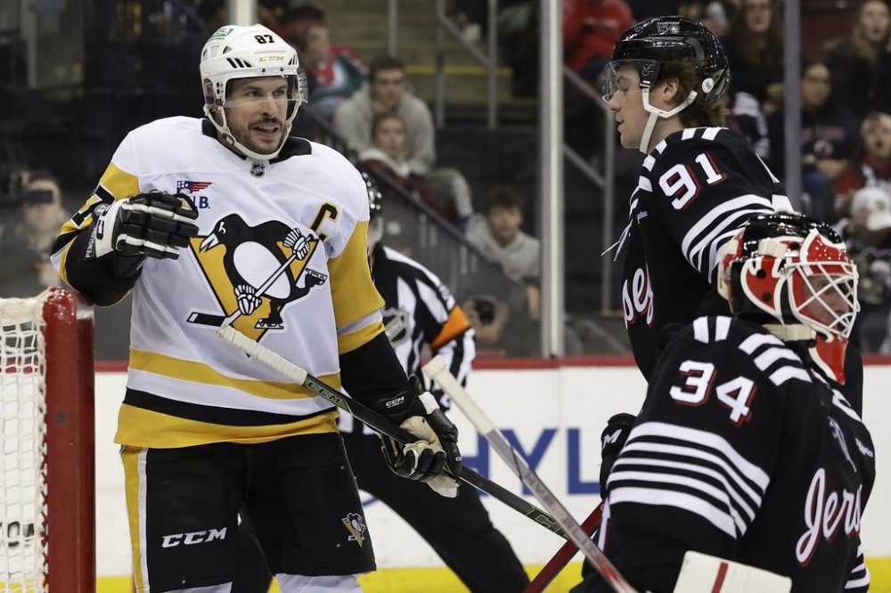 Pittsburgh Penguins center Sidney Crosby (87) reacts after scoring a goal past New Jersey Devils goaltender Jake Allen in the third period of an NHL hockey game Friday, April 11, 2025, in Newark, N.J. (AP Photo/Adam Hunger)