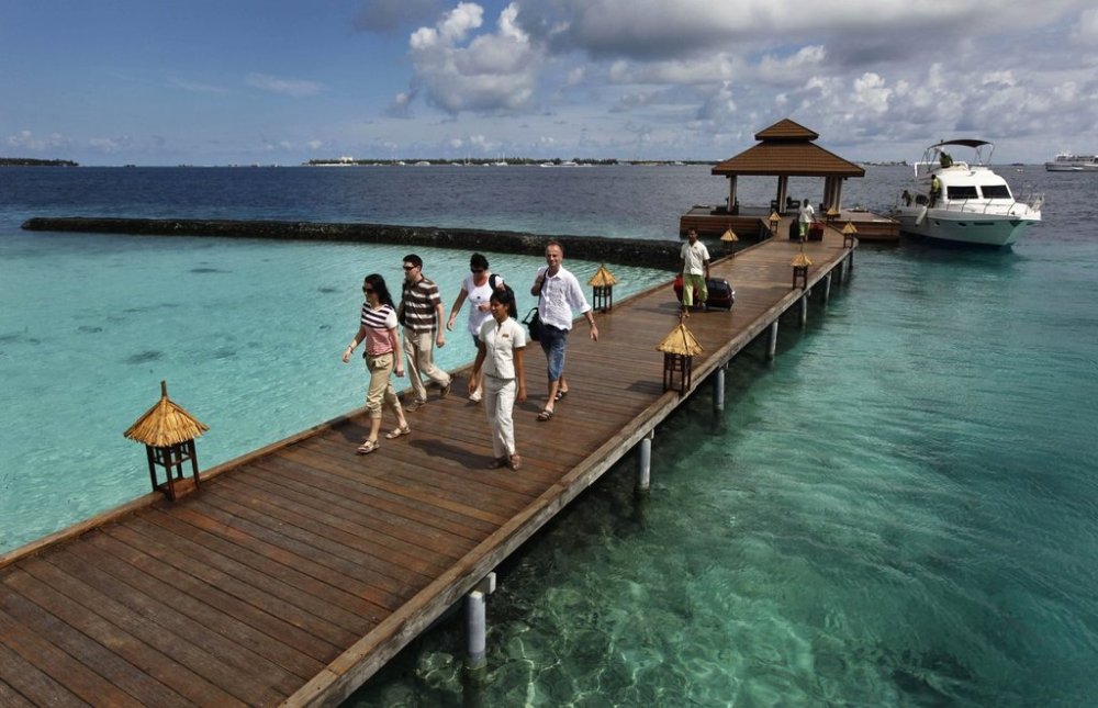 FILE- Foreign tourists arrive in a resort in the Kurumba island in Maldives, Feb. 12, 2012. (AP Photo/ Gemunu Amarasinghe, File)