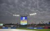 Dark skies cover Kauffamn Stadium during a rain delay of a baseball game between the Kansas City Royals and Colorado Rockies Wednesday, April 23, 2025, in Kansas City, Mo. (AP Photo/Peter Aiken)