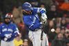 Toronto Blue Jays' Bo Bichette connects for a sacrifice fly, which scored Ernie Clement, during the 11th inning of a baseball game against the Boston Red Sox, Wednesday, April 9, 2025, in Boston. (AP Photo/Charles Krupa)