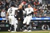Detroit Tigers' Jace Jung (17) and Trey Sweeney, right, congratulate each other after they scored on an RBI single by Gleyber Torres during the third inning of a baseball game against the San Diego Padres, Monday, April 21, 2025, in Detroit. (AP Photo/Jose Juarez)