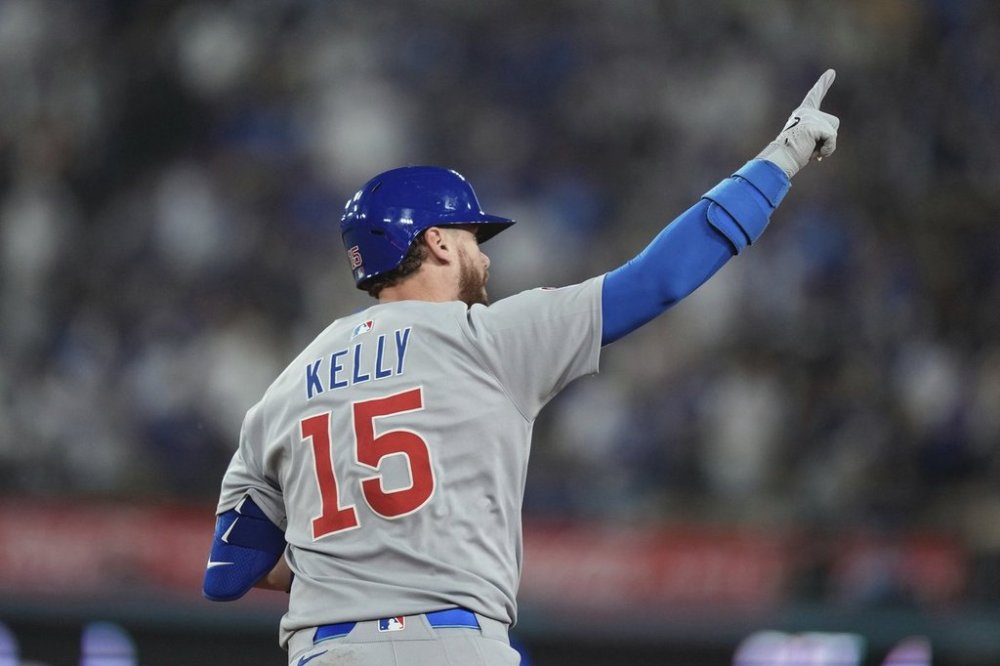 Chicago Cubs' Carson Kelly gestures as he rounds first after hitting a solo home run during the seventh inning of a baseball game against the Los Angeles Dodgers, Saturday, April 12, 2025, in Los Angeles. (AP Photo/Mark J. Terrill)