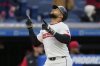 Cleveland Guardians' Carlos Santana gestures as he runs to home plate with a home run in the third inning of a baseball game against the Chicago White Sox in Cleveland, Wednesday, April 9, 2025. (AP Photo/Sue Ogrocki)