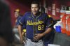 Milwaukee Brewers starting pitcher Jose Quintana pauses in the dugout during the fourth inning of a baseball game against the Arizona Diamondbacks Friday, April 11, 2025, in Phoenix. (AP Photo/Ross D. Franklin)
