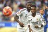Real Madrid's Vinicius Junior, right and Antonio Rudiger chase the ball during a Spanish La Liga soccer match between Alaves and Real Madrid at the Mendizorroza stadium in Vitoria, Spain, Sunday April 13, 2025. (AP Photo/Miguel Oses)