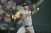 Oakland Athletics starting pitcher Jeffrey Springs throws a pitch to the Texas Rangers during the first inning of a baseball game Thursday, May 1, 2025, in Arlington, TX. (AP Photo/Julio Cortez)