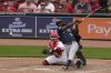 Seattle Mariners' Randy Arozarena, front right, hits a double, scoring Miles Mastrobuoni and Julio Rodríguez in the 10th inning of a baseball game against the Cincinnati Reds, Thursday, April 17, 2025, in Cincinnati. (AP Photo/Carolyn Kaster)