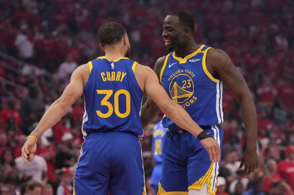 Golden State Warriors guard Stephen Curry (30) greets forward Draymond Green (23) before Game 1 of an NBA basketball first-round playoff series against the Houston Rockets in Houston, Sunday, April 20, 2025. (AP Photo/Ashley Landis)
