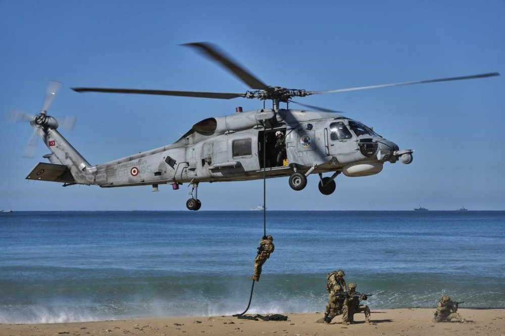 Turkish navy soldiers descend from a Sikorsky helicopter as part of the NATO Dynamic Mariner/Flotex-25 naval exercise in Barbate, southern Spain, on March 28, 2025. (AP Photo/Bernat Armangue)