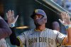 San Diego Padres' Xander Bogaerts hi fives teammates after scoring a run against the Athletics during the fifth inning of a baseball game Wednesday, April 9, 2025, in West Sacramento, Calif. (AP Photo/Sergio Estrada)