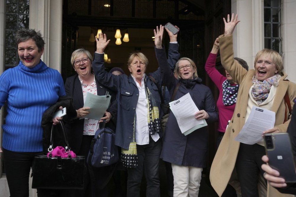 Women's rights activists celebrate outside the Supreme Court to challenge gender recognition laws, in London, Wednesday, April 16, 2025. (AP Photo/Kin Cheung)