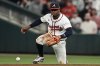 Atlanta Braves second baseman Ozzie Albies (1) loses the ball hit by Philadelphia Phillies' Bryson Stott, allowing Philadelphia Phillies' Max Kepler to score in the sixth inning of a baseball game, Wednesday, April 9, 2025, in Atlanta. (AP Photo/Mike Stewart)