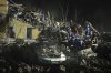 Ukrainian searchers clear the rubble after a Russian ballistic missile attack in Kyiv, Ukraine, early Thursday, April 24, 2025. (AP Photo/Efrem Lukatsky)