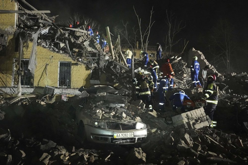 Ukrainian searchers clear the rubble after a Russian ballistic missile attack in Kyiv, Ukraine, early Thursday, April 24, 2025. (AP Photo/Efrem Lukatsky)