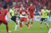 Australia's Jackson Irvine keeps control of the ball from China's Sai Erjiniao (6) and China's Baihelamu Abuduwaili (23) during a World Cup 2026 group C qualifier match held at the Hangzhou Olympic Sports Centre Stadium in Hangzhou, in eastern China's Zhejiang province, on Tuesday, March 25, 2025. (AP Photo)
