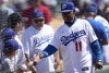 FILE - Retired Los Angeles Dodgers' Manny Mota (11) greets fans as he arrives before a spring training baseball game between the Texas Rangers and the Dodgers, March 9, 2024, in Phoenix. (AP Photo/Carolyn Kaster, file)