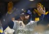 Milwaukee Brewers' Rhys Hoskins receives high-fives in the dugout after his home run against the Athletics during the third inning of a baseball game, Sunday, April 20, 2025, in Milwaukee. (AP Photo/Jeffrey Phelps)
