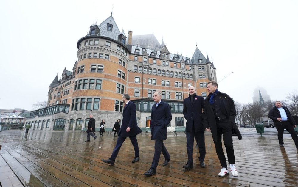 Liberal Leader Mark Carney, second from left, walks with Liberal candidate for Louise-Hebert Joel Lightbound, left, Liberal candidate for Quebec Centre Jean-Yves Duclos, second from right, and Quebec City Mayor Bruno Marchand in Quebec City on Tuesday, April 22, 2025. THE CANADIAN PRESS/Sean Kilpatrick