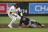 Tampa Bay Rays' Jake Mangum, right, gets tagged out by Arizona Diamondbacks third base Eugenio Suárez while trying to advance to third base in the fifth inning during a baseball game, Tuesday, April 22, 2025, in Phoenix. (AP Photo/Rick Scuteri)