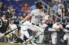 Arizona Diamondbacks' Corbin Carroll, right, watches after hitting a grand slam during the sixth inning of a baseball game against the Miami Marlins, Tuesday, April 15, 2025, in Miami. (AP Photo/Lynne Sladky)