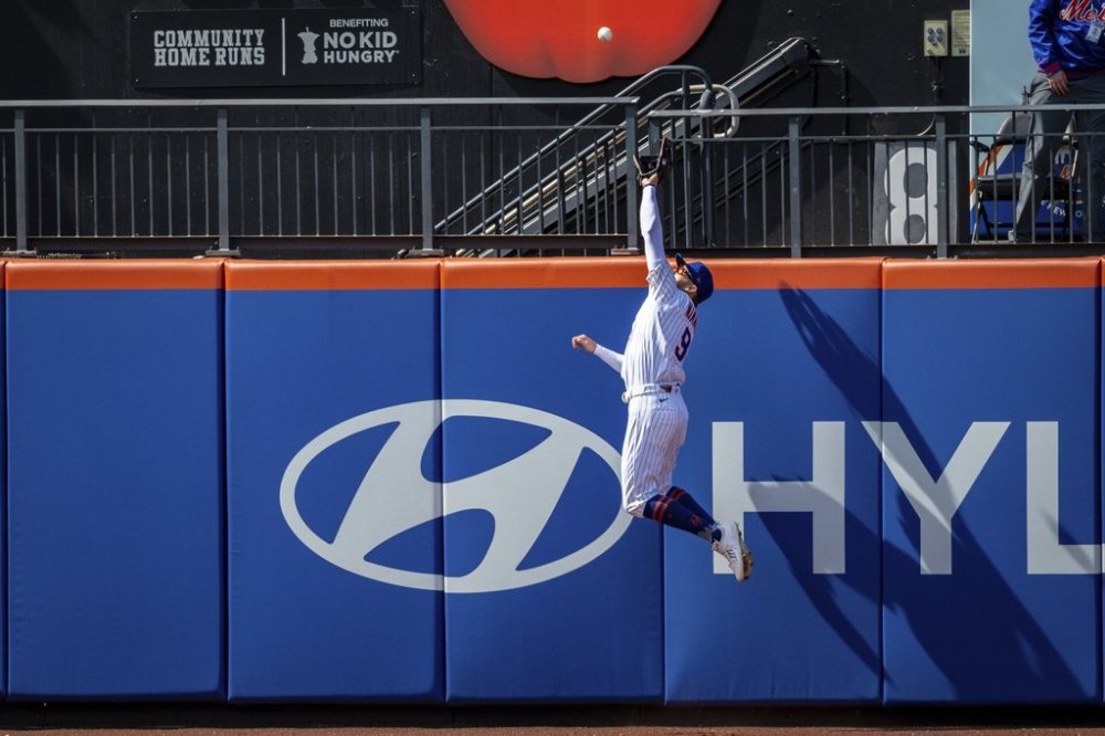 New York Mets' Brandon Nimmo (9) catches St. Louis Cardinals' Jordan Walker (18) ball, resulting in Walker flying out, during the sixth inning of a baseball game, Sunday, April 20, 2025, in New York. (AP Photo/Angelina Katsanis)