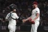 Arizona Diamondbacks catcher Jose Herrera (11) and pitcher A.J. Puk celebrate after defeating the Milwaukee Brewers in a baseball game, Sunday, April 13, 2025, in Phoenix. (AP Photo/Rick Scuteri)