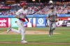 Philadelphia Phillies' Trea Turner, left, comes in to score as San Francisco Giants starting pitcher Landen Roupp, right, looks on during the first inning of a baseball game, Monday, April 14, 2025, in Philadelphia. (AP Photo/Chris Szagola)