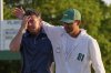 Rory McIlroy, of Northern Ireland, left, is embraced by caddie Harry Diamond after winning in a playoff against Justin Rose, of England, after the final round the Masters golf tournament, Sunday, April 13, 2025, in Augusta, Ga. (AP Photo/David J. Phillip)