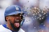 Los Angeles Dodgers' Teoscar Hernández celebrates as sunflower seeds are thrown at him after hitting home run during the fifth inning of a baseball game against the Pittsburgh Pirates in Los Angeles, Sunday, April 27, 2025. (AP Photo/Jessie Alcheh)