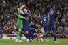 PSG's Vitinha congratulates PSG's goalkeeper Gianluigi Donnarumma after a difficult save during the Champions League semifinal first leg soccer match between Arsenal and Paris Saint-Germain at Arsenal Stadium in London, England, Tuesday, April 29, 2025. (AP Photo/Kin Cheung)