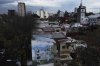 A mural of soccer stars Diego Maradona, left, and Lionel Messi adorns a wall in La Boca neigborhood in Buenos Aires, Argentina, Sunday, May 4, 2025. (AP Photo/Natacha Pisarenko)