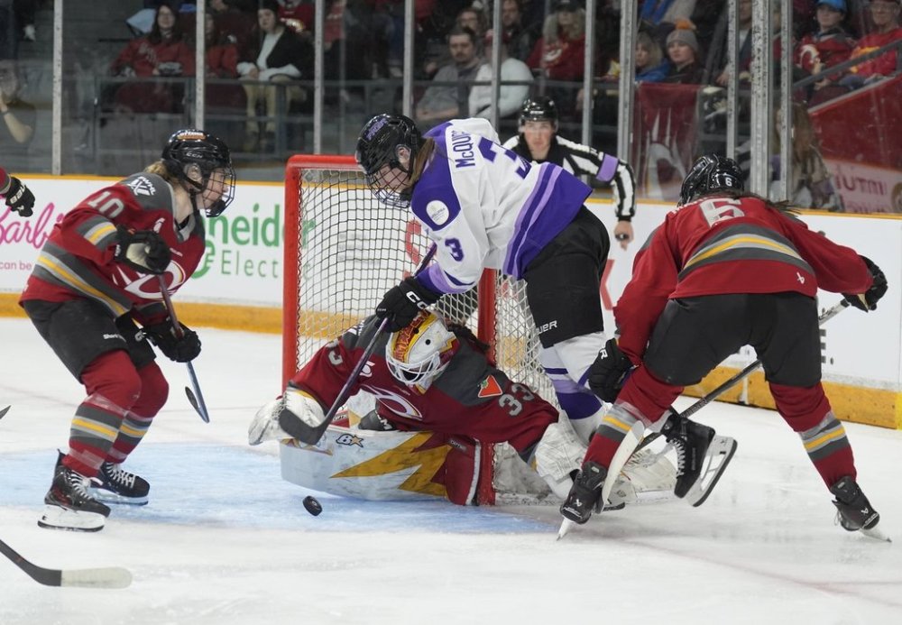 Minnesota Frost forward Brooke McQuigge (3) is stopped by Ottawa Charge goalie Gwyneth Philips (33) under pressure from Ottawa Charge defence Stephanie Markowski (6) and forward Alexa Vasko (10) during second period PWHL action, Wednesday, April 30, 2025 in Ottawa. THE CANADIAN PRESS/Adrian Wyld