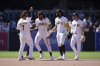 San Diego Padres right fielder Fernando Tatis Jr., center, celebrates with teammates after the Padres defeated the San Francisco Giants 5-3 in a baseball game Wednesday, April 30, 2025, in San Diego. (AP Photo/Gregory Bull)
