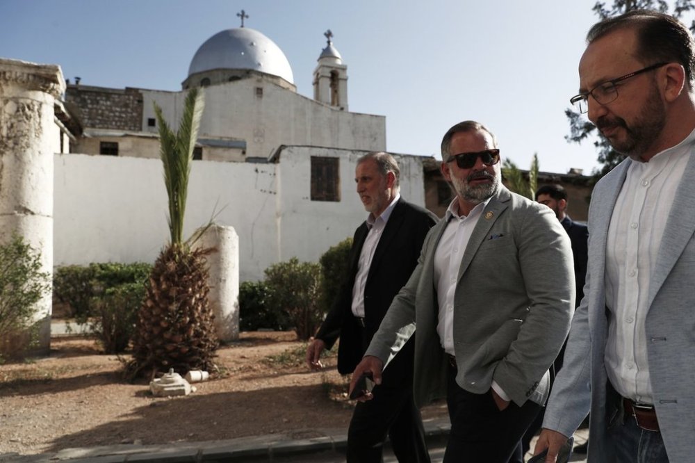 Accompanied by unidentified members of the delegation, U.S. congressman Cory Mills (R-FL), second from right, walks in the Old City of Damascus Friday, April 18, 2025. Mills is in Damascus in an unofficial visit organized by a Syrian-American nonprofit, the first visit by U.S. legislators since the fall of former Syrian President Bashar Assad in December.(AP Photo/Omar Sanadiki)
