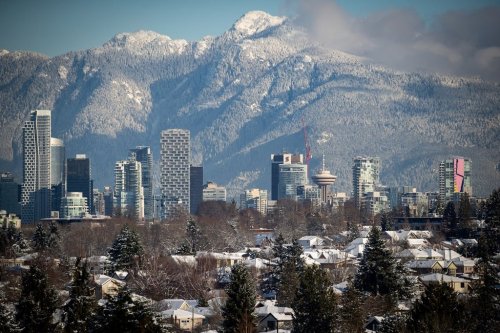 Spring is a dangerous time to head into British Columbia's backcountry, outdoor experts warn, as sun and warm daytime temperatures melt snowpack that can become hard and treacherously slippery as it freezes again overnight. Snow-covered houses and the downtown skyline are seen with the north shore mountains in the distance after 21 centimetres of snow fell overnight, in Vancouver, on Thursday, December 30, 2021. THE CANADIAN PRESS/Darryl Dyck