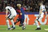 Barcelona's Lamine Yamal, center, is challenged by Inter Milan's Carlos Augusto, left, and Inter Milan's Henrikh Mkhitaryan during the Champions League semifinal first leg soccer match between Barcelona and Inter Milan at the Lluis Companys Olympic Stadium in Barcelona, Spain, Wednesday, April 30, 2025. (AP Photo/Joan Monfort)