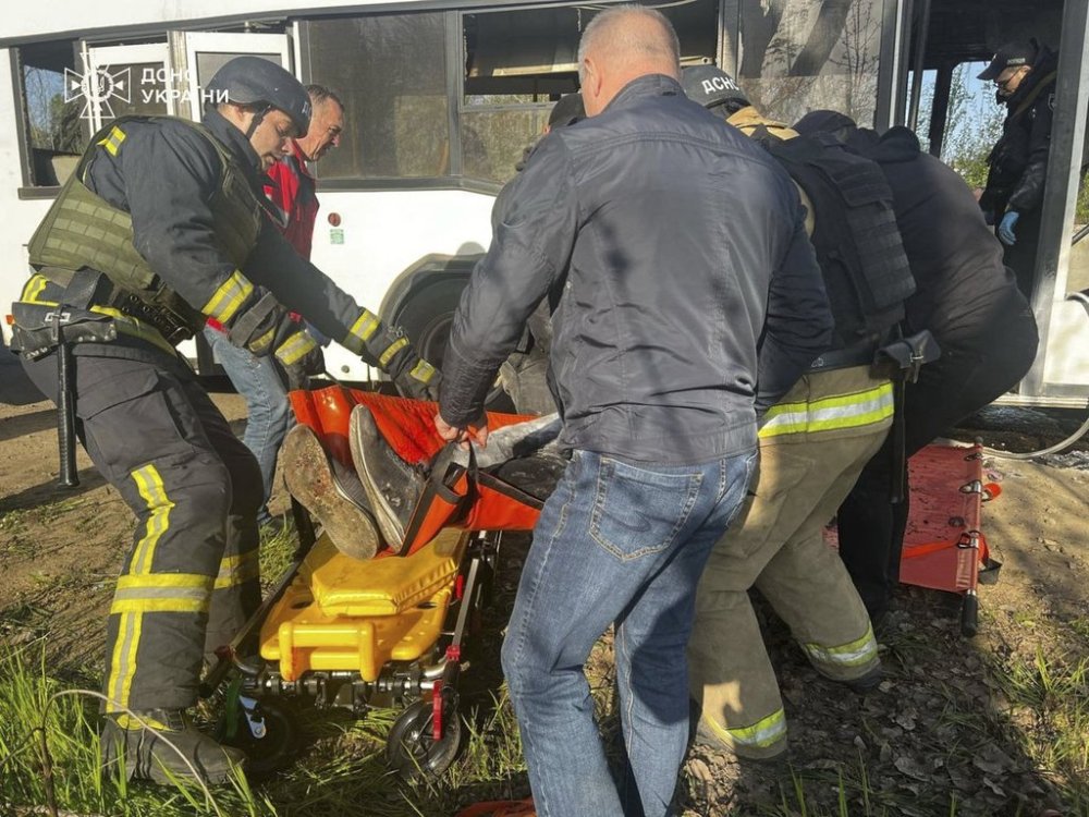 In this photo provided by the Ukrainian Emergency Service, rescuers carry out bodies of passengers after a Russian drone hit a public bus in Marhanets, Dnipropetrovsk region, Wednesday, April 23, 2025. (Ukrainian Emergency Service via AP)
