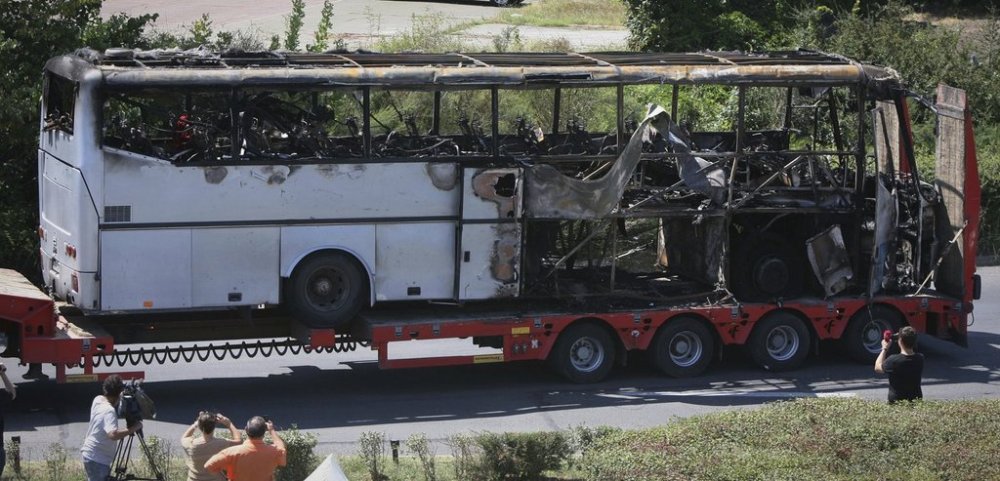 FILE - A damaged bus is transported out of Burgas airport, a day after a deadly suicide attack on a bus full of Israeli vacationers, Bulgaria, Thursday, July 19, 2012. (AP Photo/Impact Press Group, File)