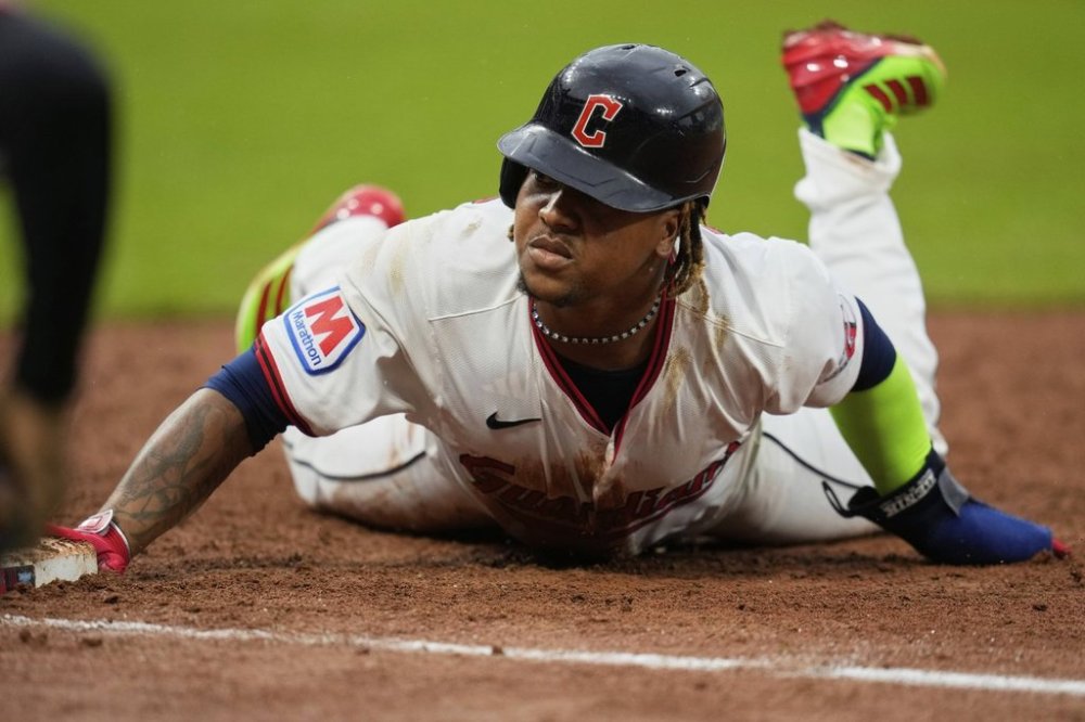 Cleveland Guardians' Jose Ramirez dives back into first base on a pickoff-attempt in the 10th inning of a baseball game against the Minnesota Twins in Cleveland, Thursday, May 1, 2025. (AP Photo/Sue Ogrocki)