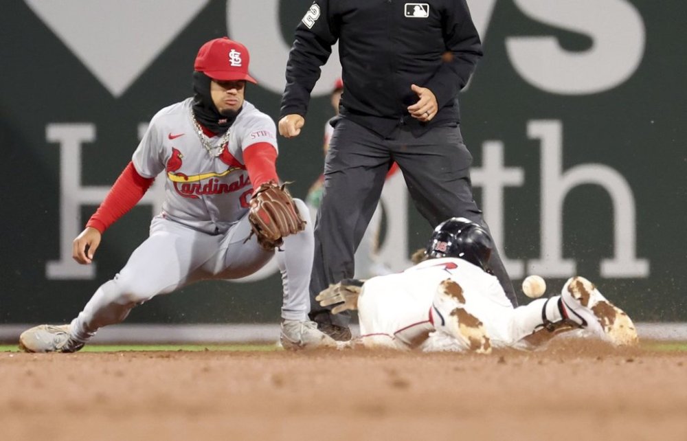 St. Louis Cardinals shortstop Masyn Winn, left, comes up short on a tag against Boston Red Sox's Jarren Duran, right, in the fifth inning during the second baseball game of a doubleheader, Sunday, April 6, 2025, in Boston. (AP Photo/Mark Stockwell)
