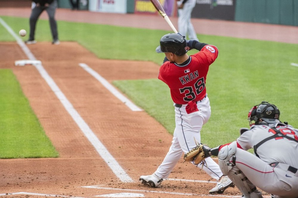 Cleveland Guardians' Steven Kwan (38) hits a double off Boston Red Sox starting pitcher Tanner Houck as catcher Blake Sabol looks on during first inning in the first baseball game of a doubleheader Saturday, April 26, 2025. in Cleveland, (AP Photo/Phil Long)