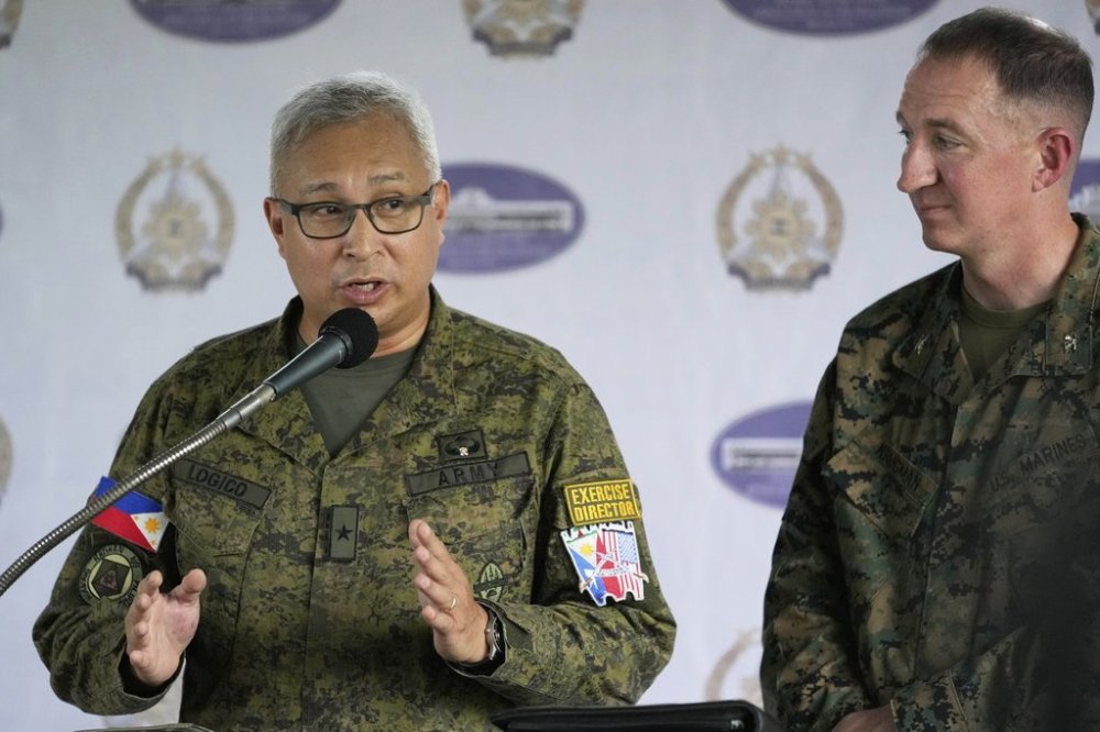 Philippine Brig. Gen. Michael Logico, left, gestures beside US Marine Corps Colonel Doug Krugman of the 1st Marines Expeditionary Force as he answers questions regarding the upcoming joint military exercises during a press conference at Camp Aguinaldo military headquarters in Quezon city, Philippines, Tuesday, April 15, 2025. (AP Photo/Aaron Favila)