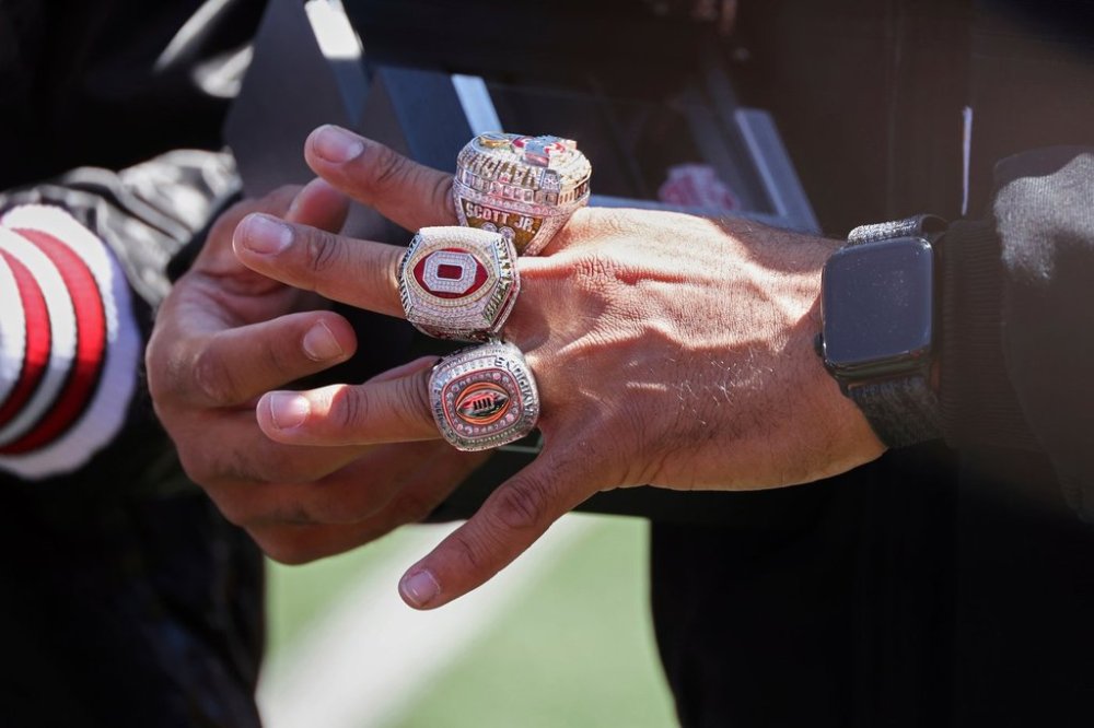 Ohio State's Gee Scott Jr. admires his NCAA college football championship rings during the school's spring football game, Saturday, April 12,2 025, in Columbus, Ohio. (David Petkiewicz/Cleveland.com via AP)