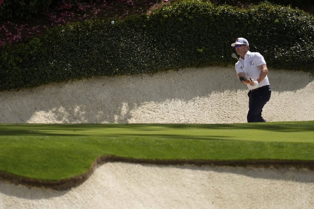 Zach Johnson hits from the bunker on the 12th hole during the second round at the Masters golf tournament, Friday, April 11, 2025, in Augusta, Ga. (AP Photo/Ashley Landis)