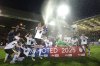 Birmingham City players celebrate promotion after the Sky Bet League One soccer match against Peterborough United at the Weston Homes Stadium, Tuesday April 8, 2025, in Peterborough, England. (Joe Giddens/PA via AP)