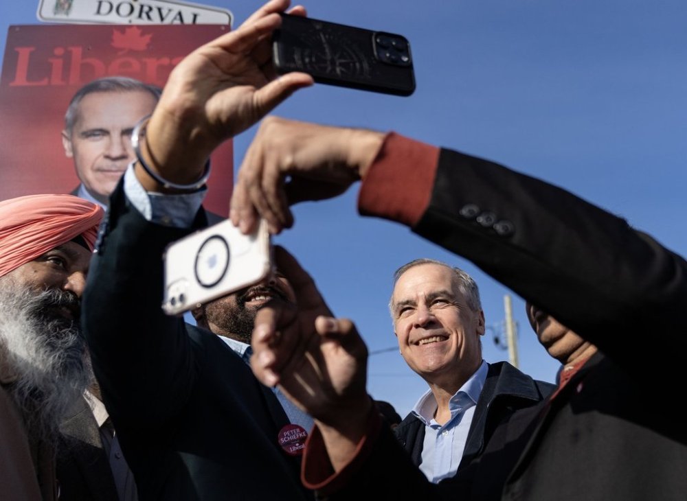 Liberal Leader Mark Carney is greeted by supporters prior to departing from Montreal, Friday, April 18, 2025. THE CANADIAN PRESS/Christinne Muschi