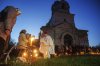 Priest Serhii Zezul blesses Easter baskets in front of a church destroyed in fighting between Russian and Ukrainian forces, during celebration of the Orthodox Easter in Lukashivka village, Ukraine, on Sunday, April 20, 2025. (AP Photo/Evgeniy Maloletka)