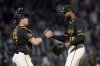 Pittsburgh Pirates pitcher Dennis Santana, right, celebrates with catcher Henry Davis, left, after getting the final out of a baseball game against the Washington Nationals, Monday, April 14, 2025, in Pittsburgh. (AP Photo/Matt Freed)